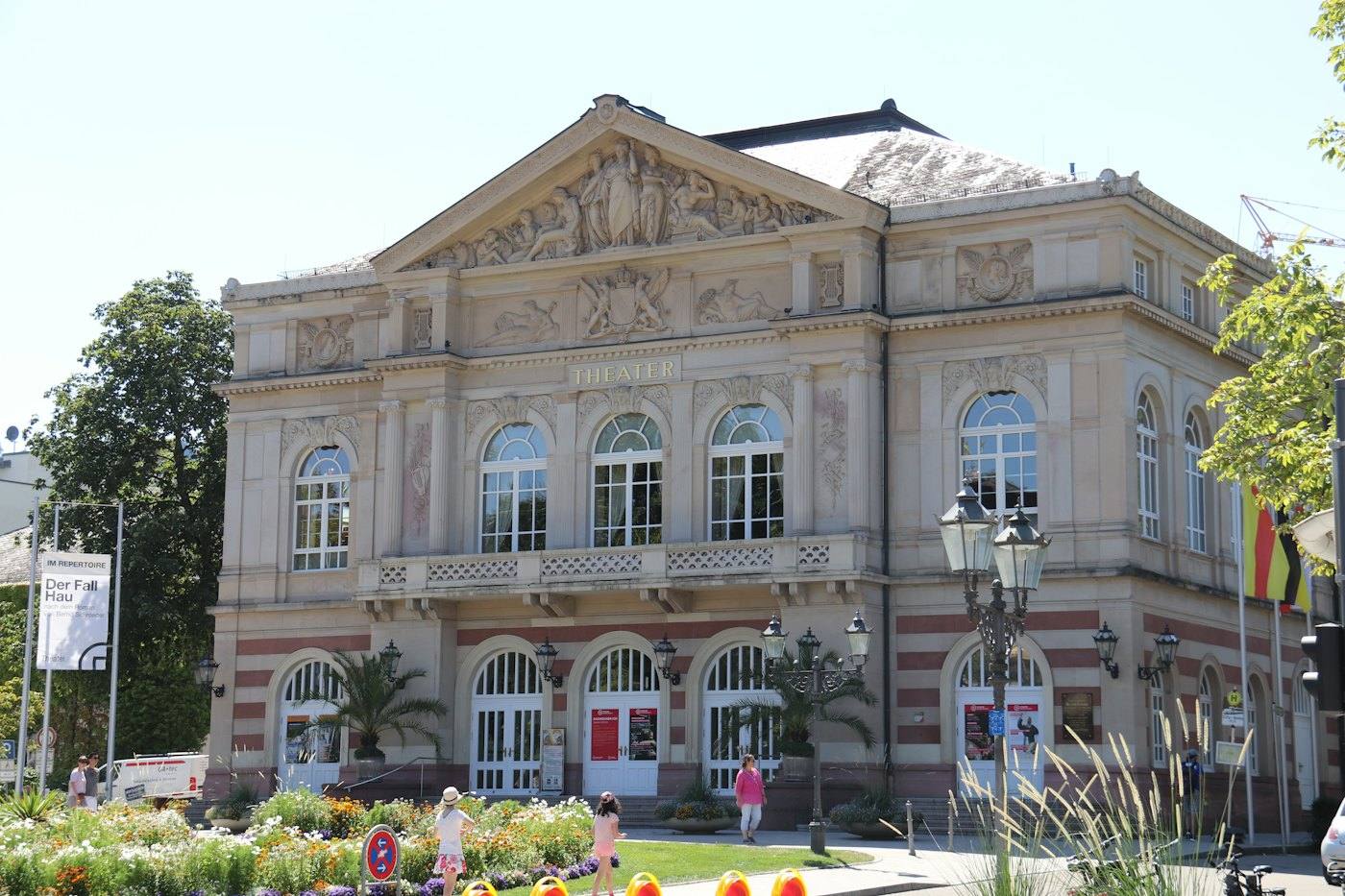 Classical theatre building with flower beds in front