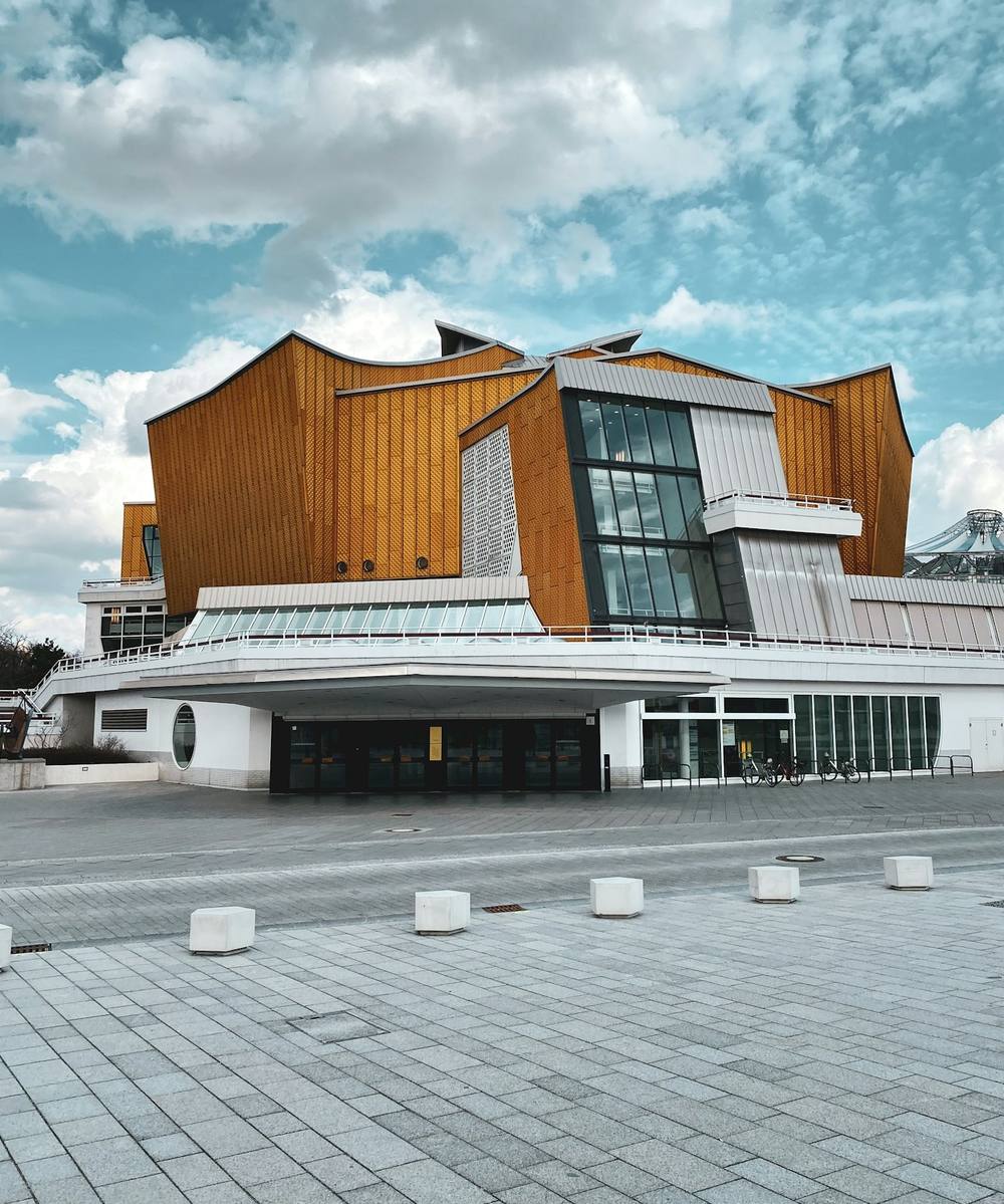 Golden tent-like concert hall under a blue sky