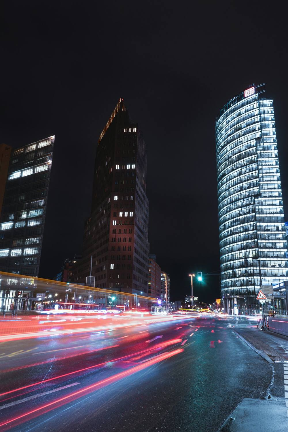 Towers at Potsdamer Platz at night with light trails of cars